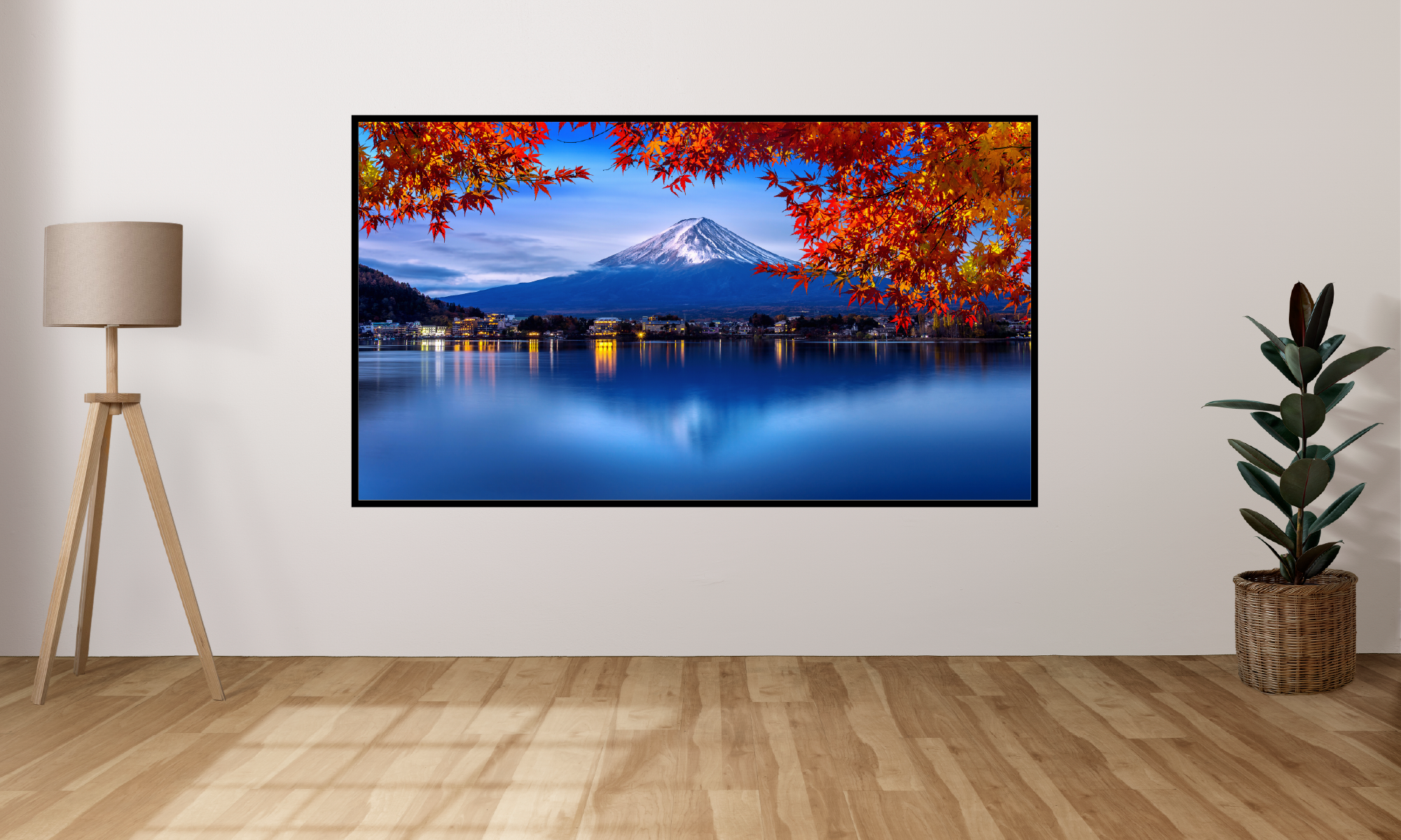 projected image on a wall displaying a scenic view of a mountain and lake with autumn foliage.